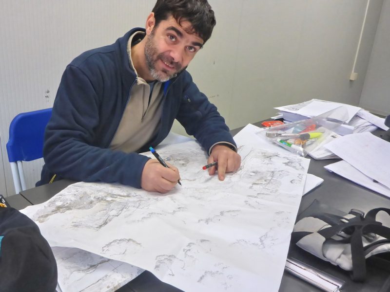 Dr. Marco Marrosu drawing data on the map
